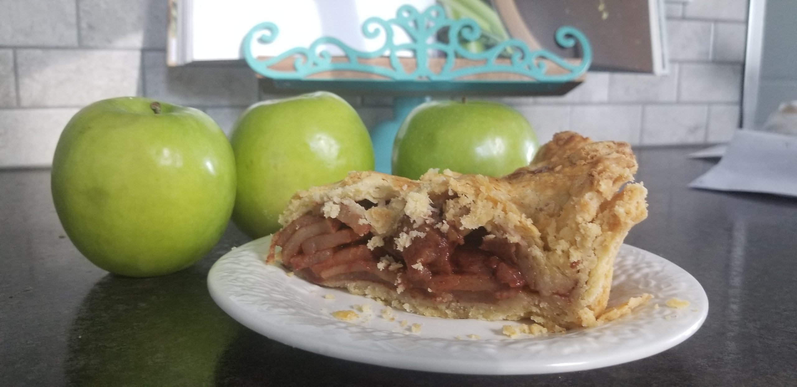 slice of apple pie and 3 apples